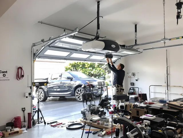 Matthews Garage Door Repair specialist installing smart garage door opener system in Matthews home